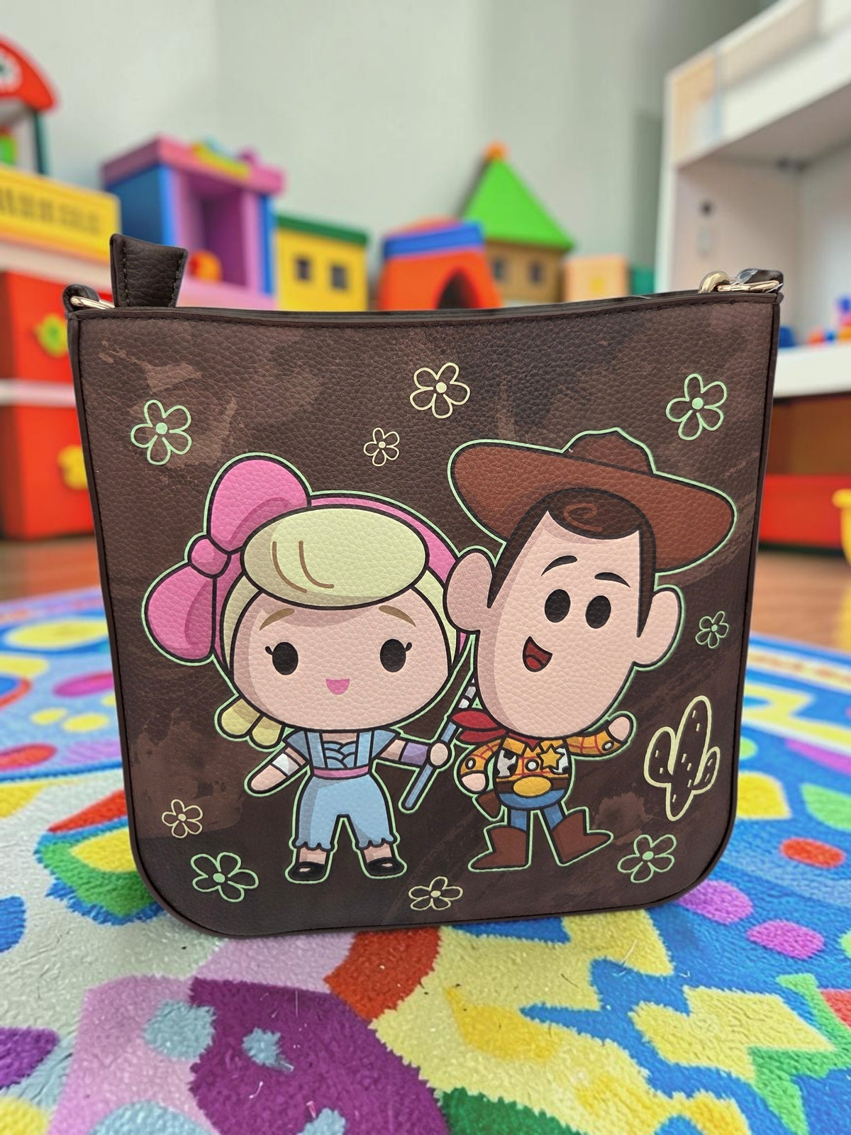 Momof2boyz Shop Toy Story WondaPop crossbody bag featuring Bo Peep and Woody on a brown faux leather background.
