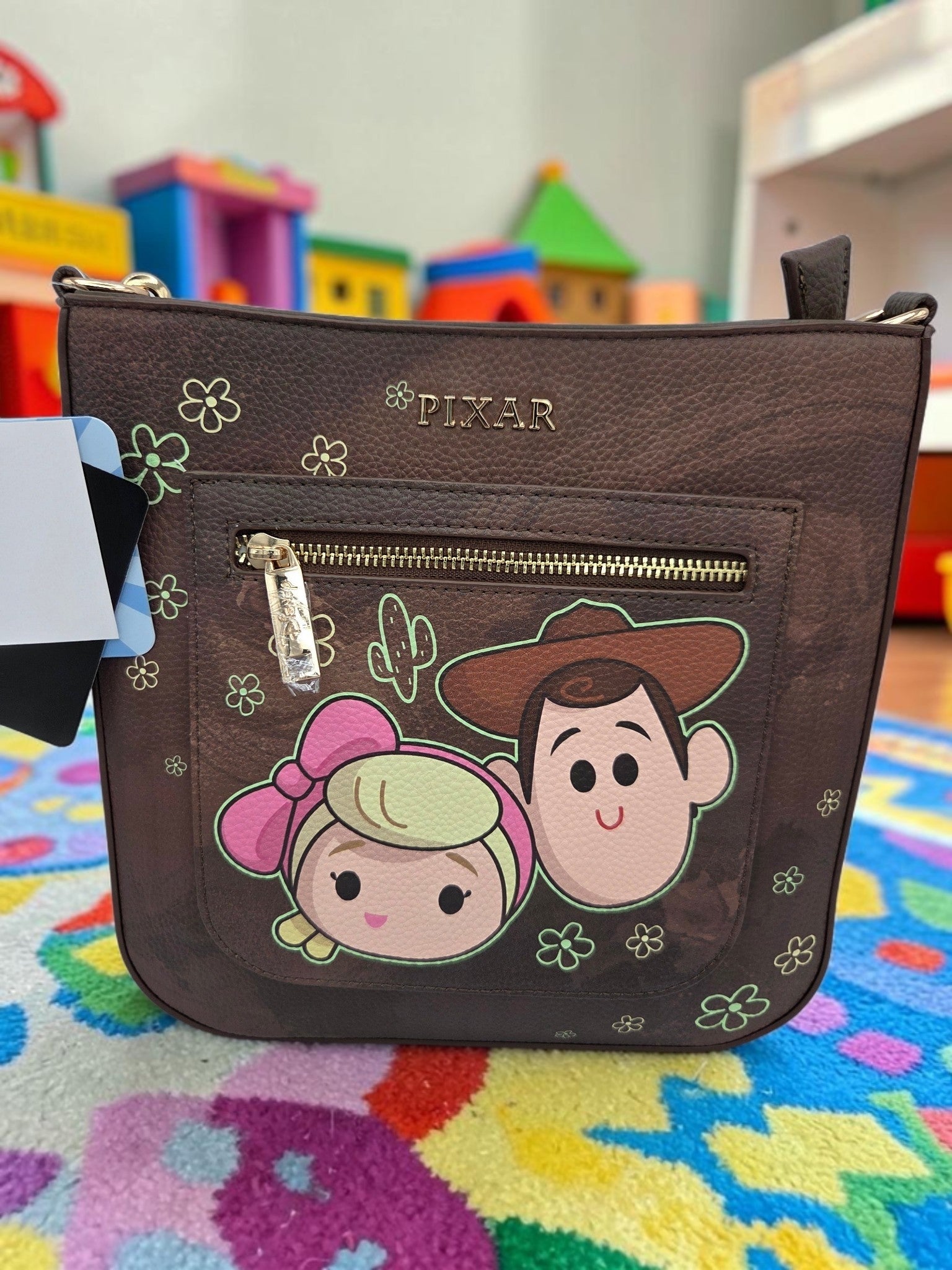 Momof2boyz Shop Toy Story WondaPop crossbody bag in brown featuring Woody and Bo Peep with floral and cactus details