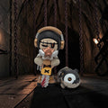 Momof2boyz Shop Wicked Union Mr. Bones designer art toy figure with a chainsaw and companion pet in a dungeon setting.