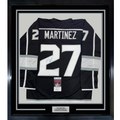Framed Autographed/Signed Alec Martinez 35x39 Los Angeles LA Black Hockey Jersey JSA COA